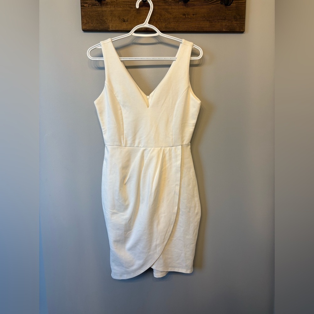 White Asymmetrical Mini Dress with a deep v neckline in size Medium